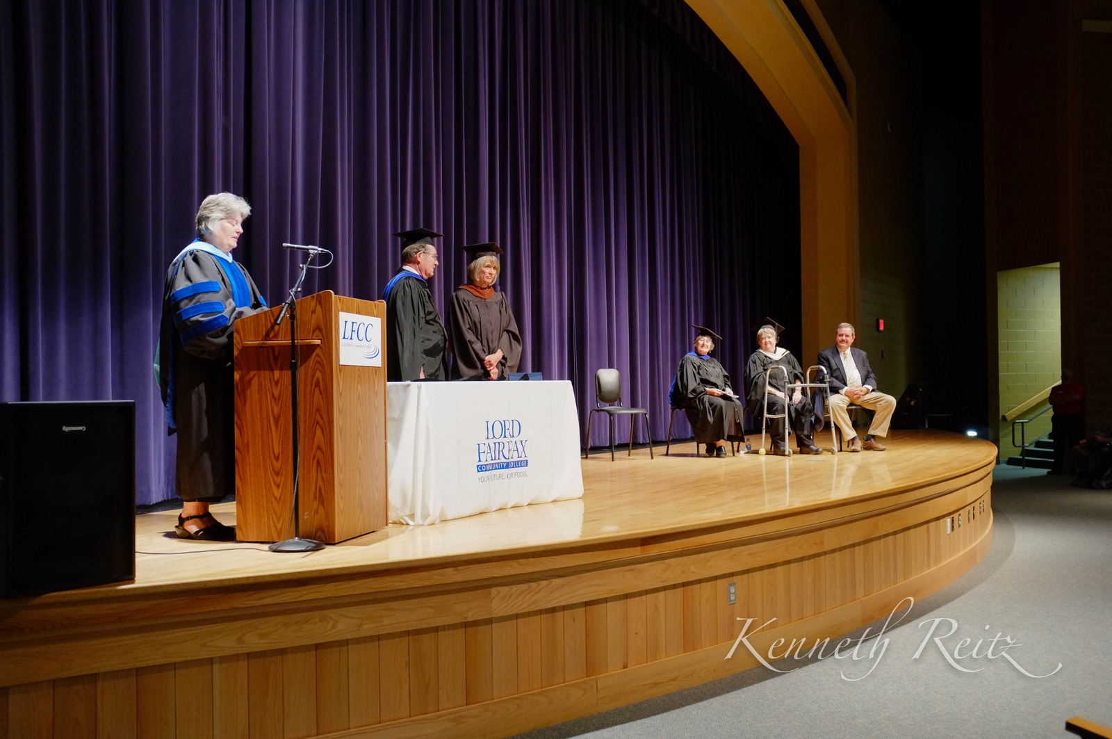 Graduation Ceremony Under Purple Drapes