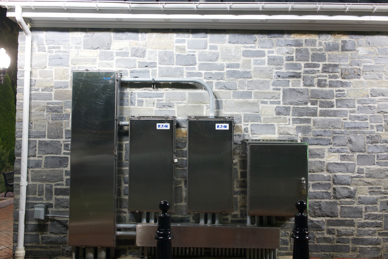 Industrial Contrast on Stone Wall