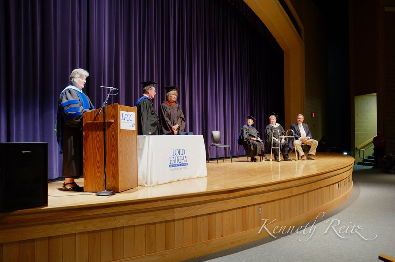 Graduation Ceremony Under Purple Drapes